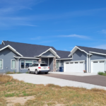 Blue house with white garage doors